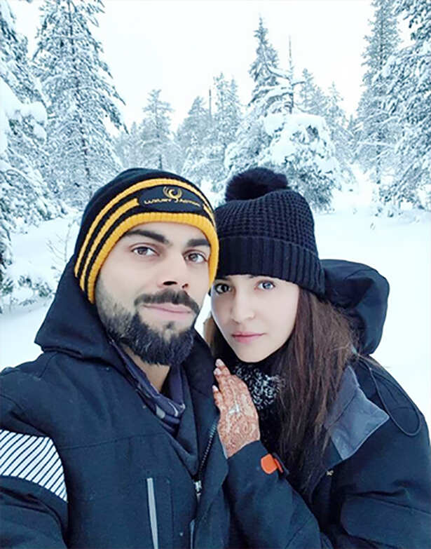 Peck it out! Virat Kohli and Anushka Sharma lock it with love