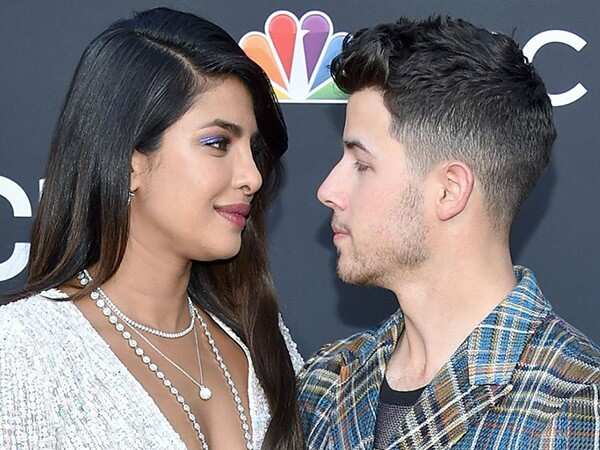 Nick Jonas plants a kiss on Priyanka Chopra at the Billboard Music