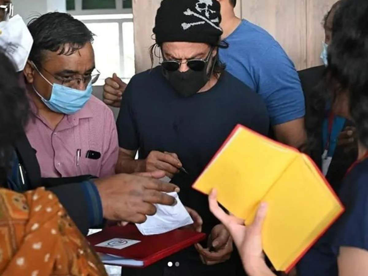 Shah Rukh Khan signing autographs for fans.