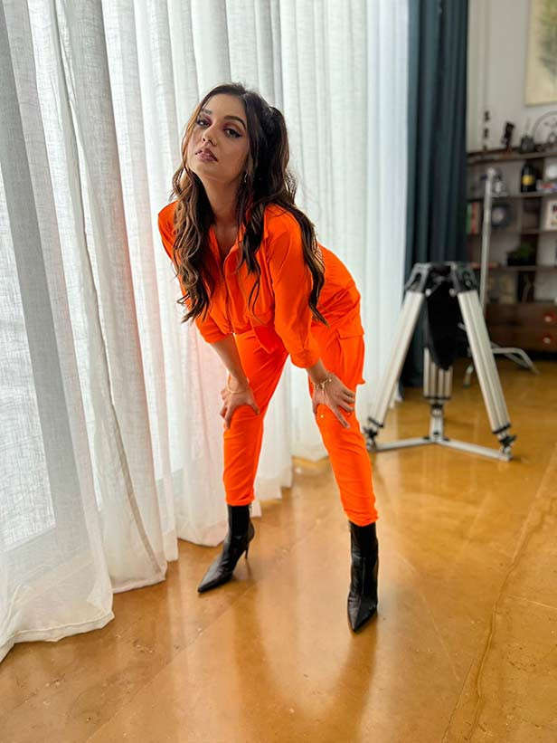 Divya Aggarwal in orange jumpsuit.