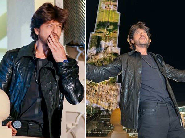 Shah Rukh Khan does his iconic pose as Pathaan's trailer plays at the Burj Khalifa