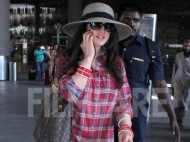 A very busy Preity Zinta clicked at the airport