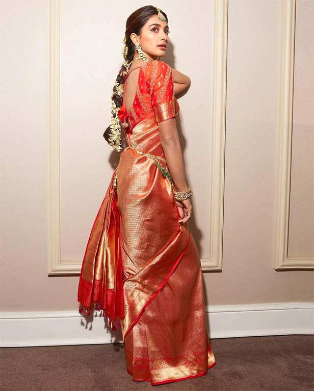 Pooja Hegde shines bright in a vivid orange kanjivaram saree | Filmfare.com