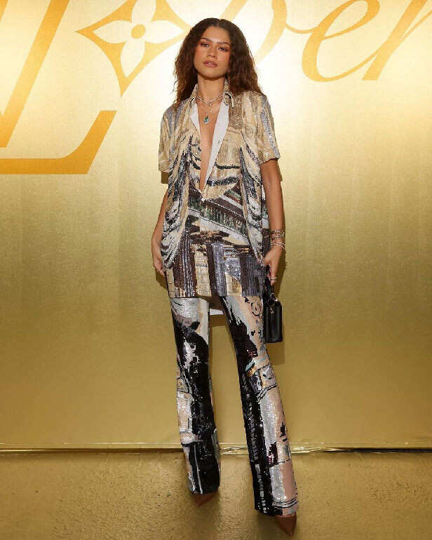 Zendaya aces a shimmering prints pantsuit as she attends a fashion show ...